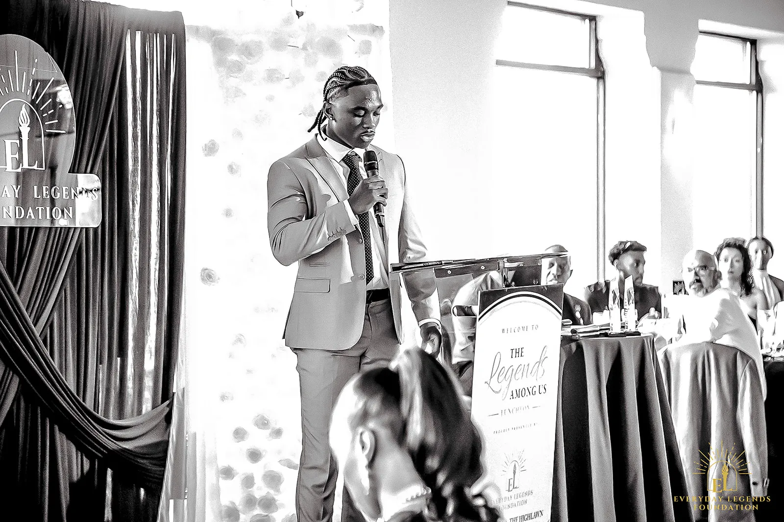 Jaylen McClain speaks at the lectern at the Legends Among Us luncheon.