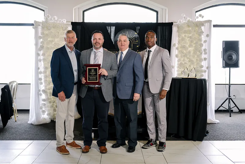 Representatives of the Seton Hall Prep Football Program hold the program's award plaque at the Legends Among Us luncheon.