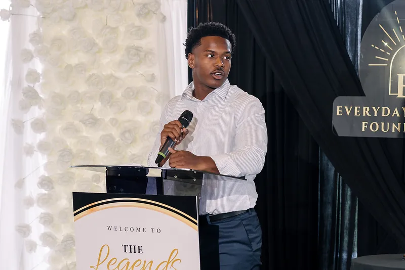 Nathan Bailey speaks at the lectern at the Legends Among Us luncheon.