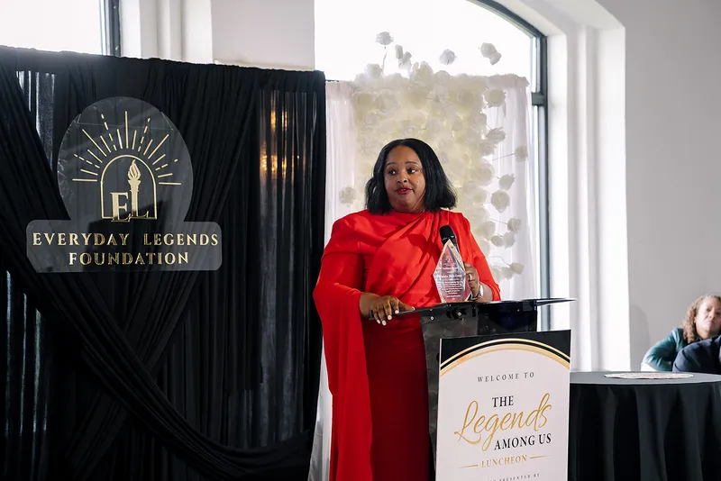 Natasha Davis-Gomez at the lectern with her award at the Legends Among Us luncheon.